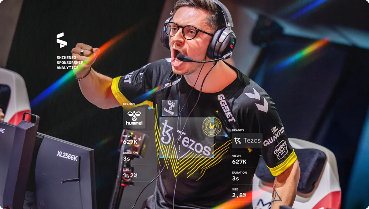 Team Vitality esports player celebrating mid-match with Hummel and Tezos sponsor logos highlighted and view analytics shown.