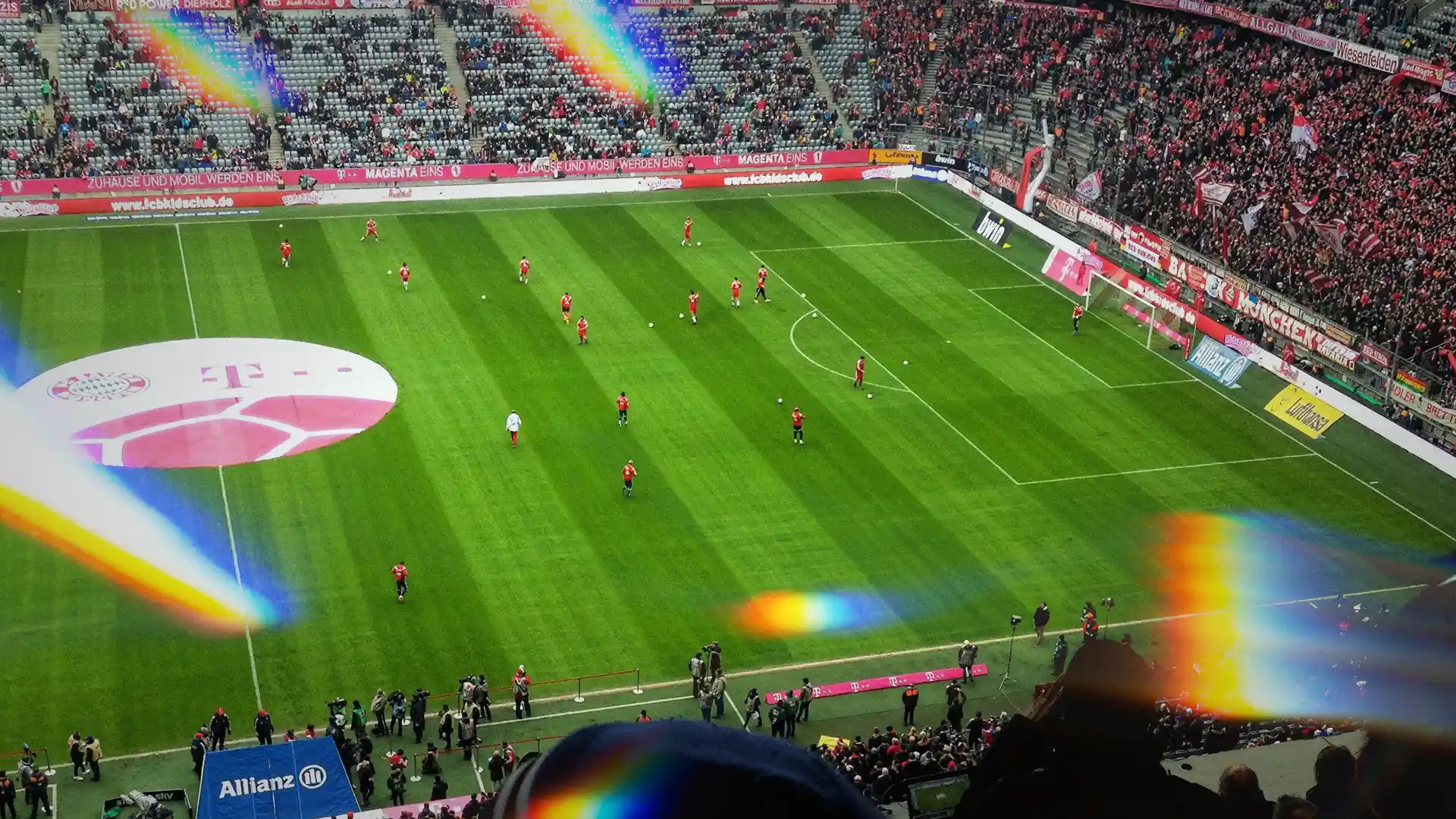 Wide stadium view during a live football match, showing perimeter advertising boards and sponsor logos around the pitch, highlighting in-stadium brand exposure and media value opportunities.