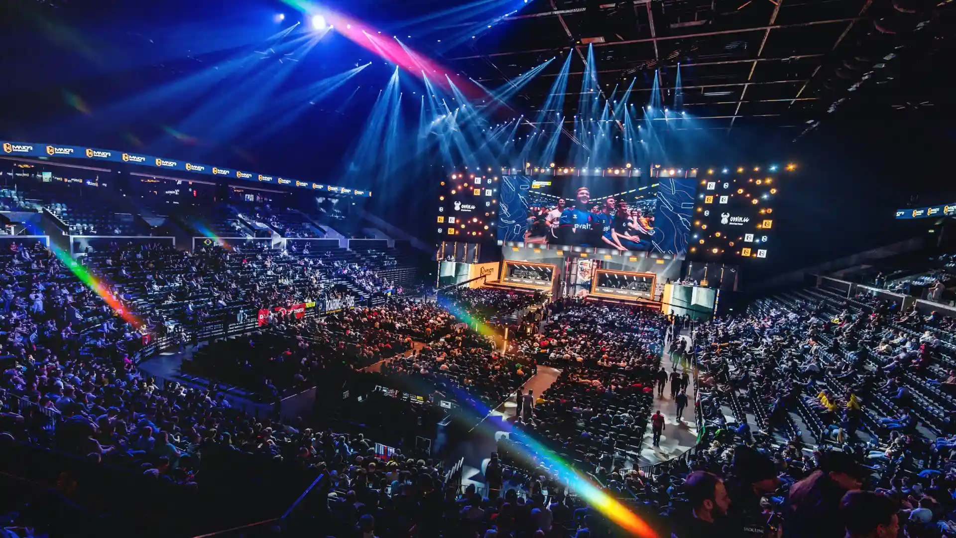 Large esports arena filled with spectators watching a live gaming tournament.