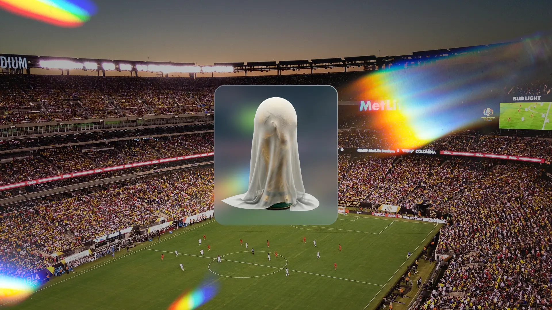 MetLife Stadium filled with fans during a football match, with the official FIFA World Cup 2026 trophy covered in the centre