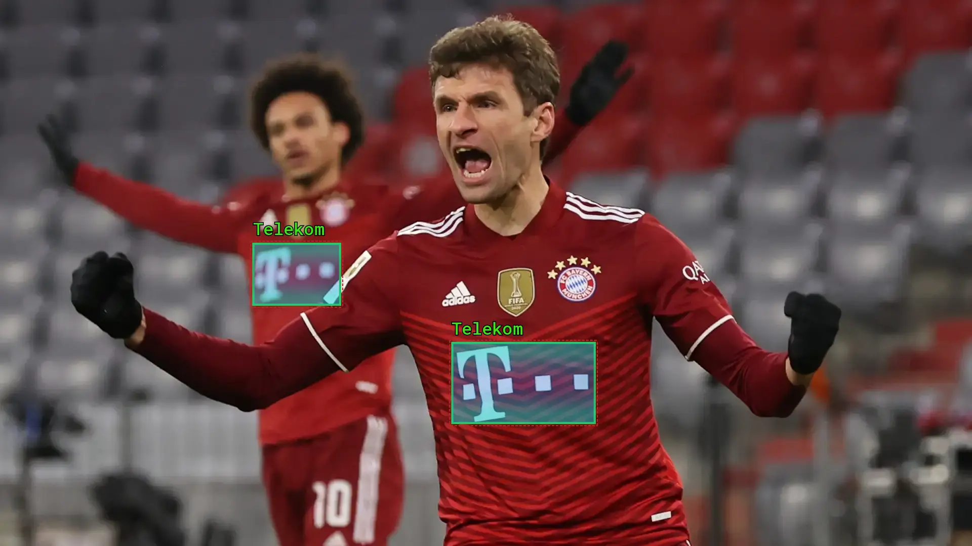 Thomas Muller celebrating a goal during a match wearing a red team kit with visible sponsor logos, highlighting the power of athlete endorsement and brand exposure in live sports.